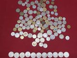 a pile of coins on a table with a red background