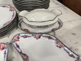 many plates and bowls sitting on a table