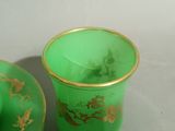 a green cup and saucer sitting next to each other on a table