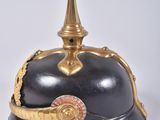 an old helmet with a gold decoration on top of it