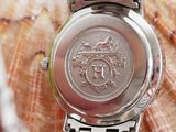 a close up of a watch on a seashell