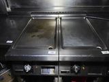 two stainless steel sinks in the middle of a kitchen
