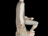 a figurine of a man sitting on a rock