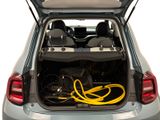 the back of a car with the trunk open and a yellow hose in the trunk