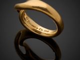 a close up of a gold ring on a black surface
