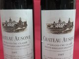 two bottles of wine sitting next to each other on a table