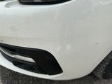a close up of the front bumper of a white car