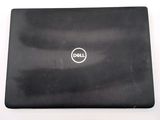dell laptop computer sitting on top of a white surface with a logo on the screen