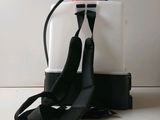 a white and black backpack with a red and white sprayer attached to it