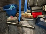 a broom, bucket, mop, and bucket of cleaning supplies on the floor
