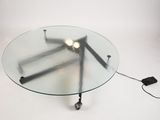 a glass table with a lamp on top of it