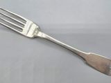 silver plated fork on a white surface with a fork in the middle