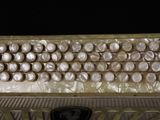 a close up of an accordion with buttons on it