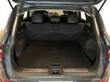 the back of a car with the trunk open and the back seats down