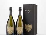 two bottles of champagne in front of a black box