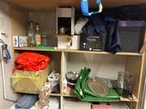 a small kitchen with a lot of clutter on the shelves