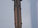 a metal object with a wooden handle on a table