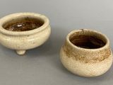 two small bowls sitting next to each other on a table