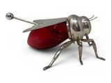 a metal insect with a red nose and legs