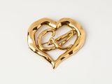 gold heart brooch with intertwined hearts on white background
