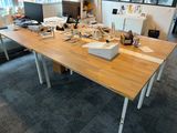 a desk with a lot of clutter on it in a room