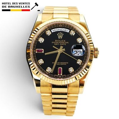 a close up of a gold wrist watch with a black dial