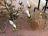 a vase of flowers and a candle holder on the ground
