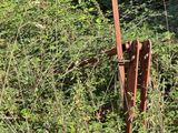 a rusted metal object sitting in the middle of a field