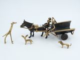 a figurine of a horse pulling a carriage with people and dogs