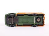 a green and orange toy truck on a white surface