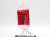 a bag of candy sitting on top of a black stand