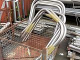 a metal cart that has a bunch of metal pipes in it