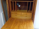 a small wooden desk with a drawer underneath it