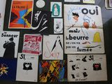 many different posters on the wall of a bathroom