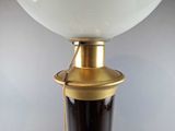 a close up of a lamp with a glass shade on it