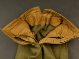 an image of a green jacket with a brown hood and a green scarf