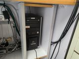 a computer that is sitting on a shelf in a room