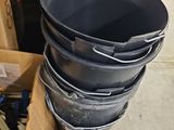 several buckets are stacked on top of each other in a room