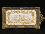 an antique picture frame with a painting of two cherensils