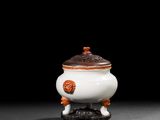 un vase blanc et orange posé sur une table noire