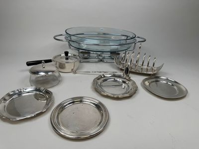 a lot of silver plates and silverware on the table