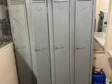 two lockers in a bathroom with a toilet and a sink