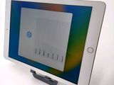 a tablet that is sitting on a stand on a table