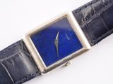 a close up of a watch with a blue face