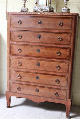 a dresser with a mirror on top of it in a room
