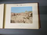 an open book with a picture of a town on it