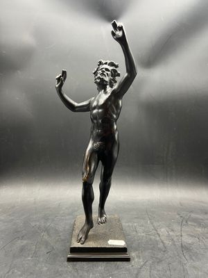 statue of a man with a fist in his hand on a pedestal