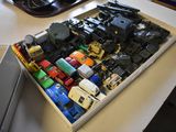 a box full of toy cars sitting on a desk