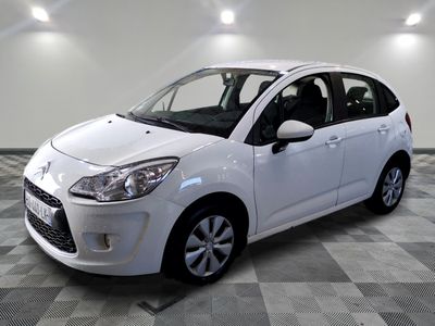 a picture of a white car parked in a garage