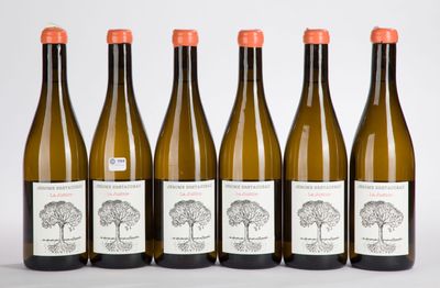 six bottles of wine are lined up in a row